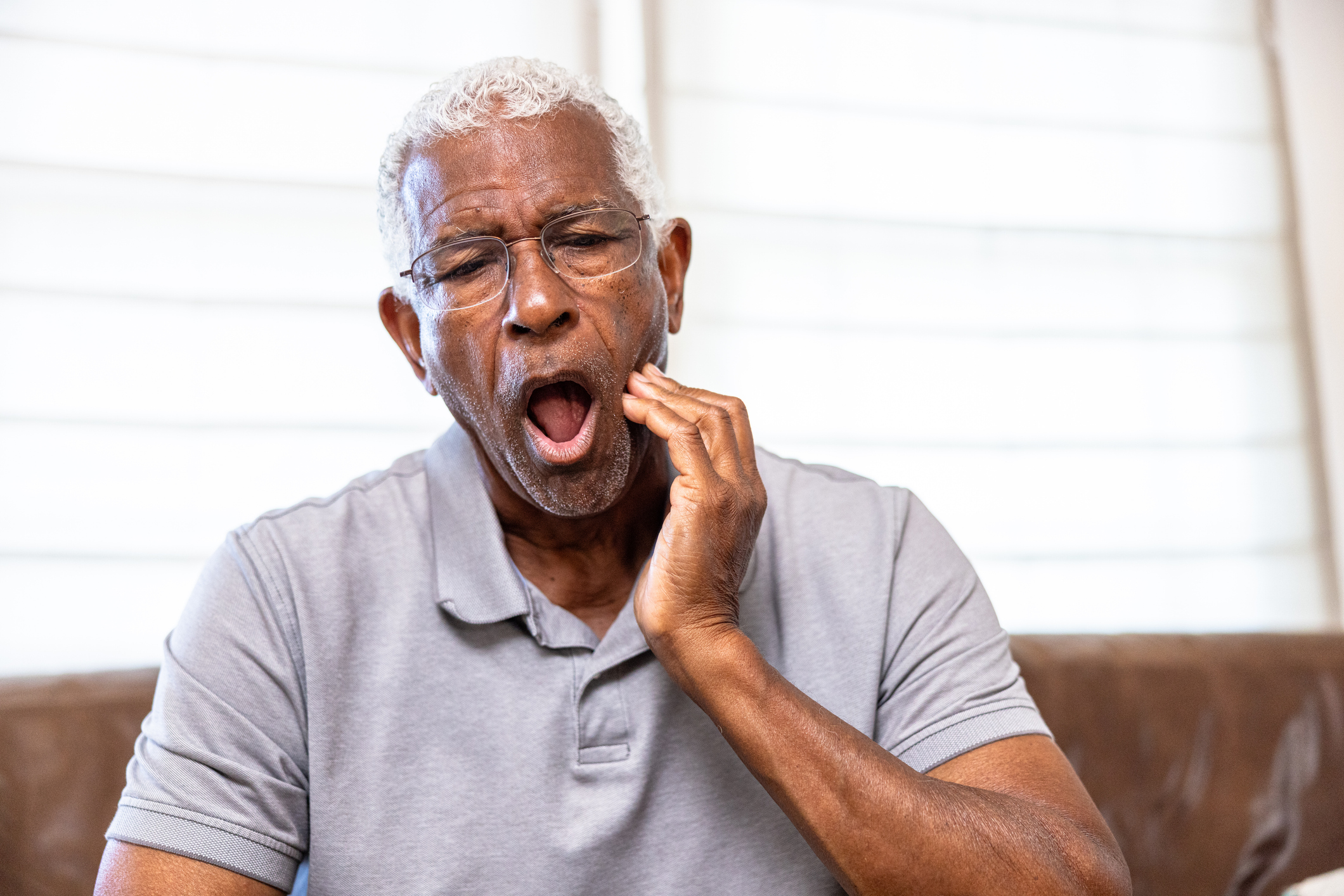 Man holding his jaw in pain