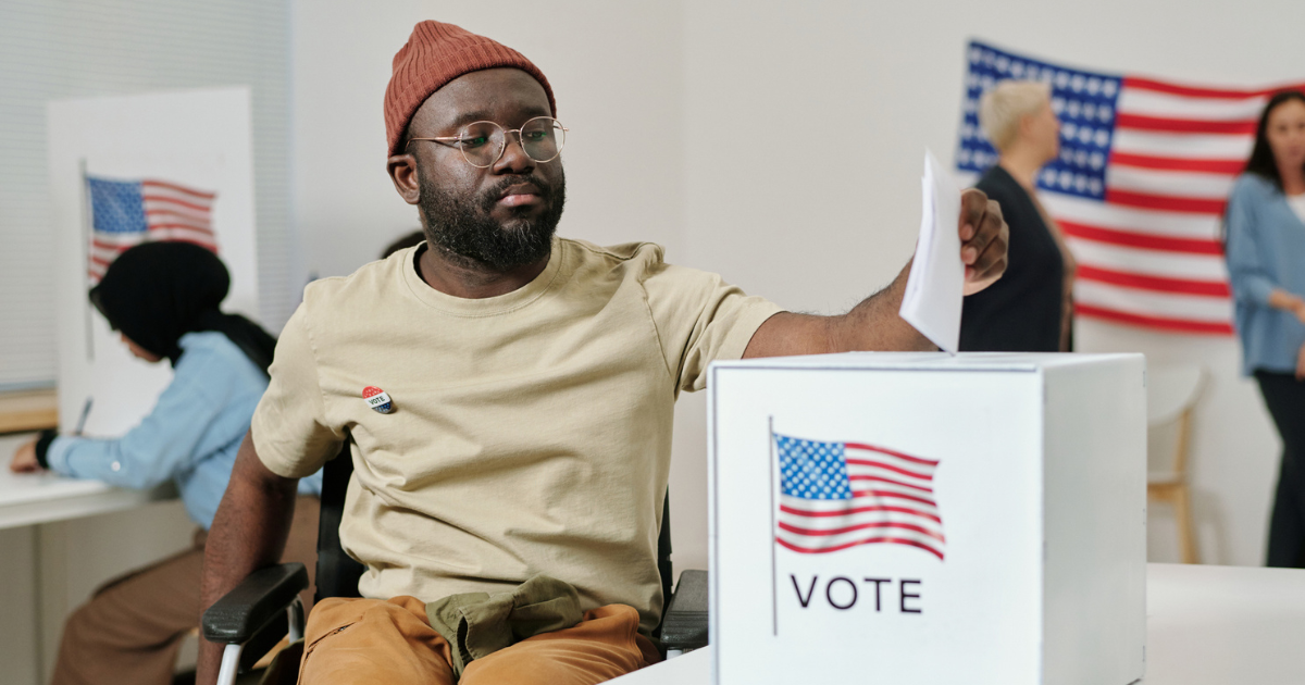 Man in a wheelchair casting a ballot