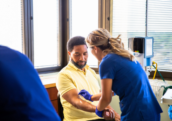 Men getting blood drawn by nurse