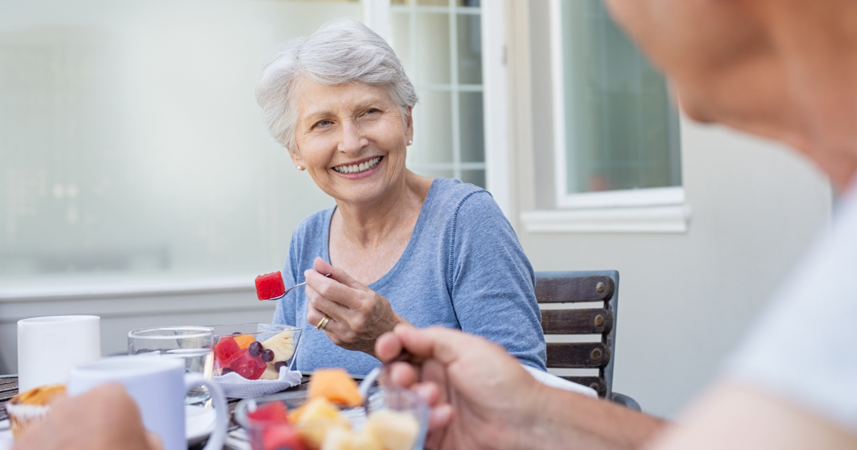 Older woman eating fruit