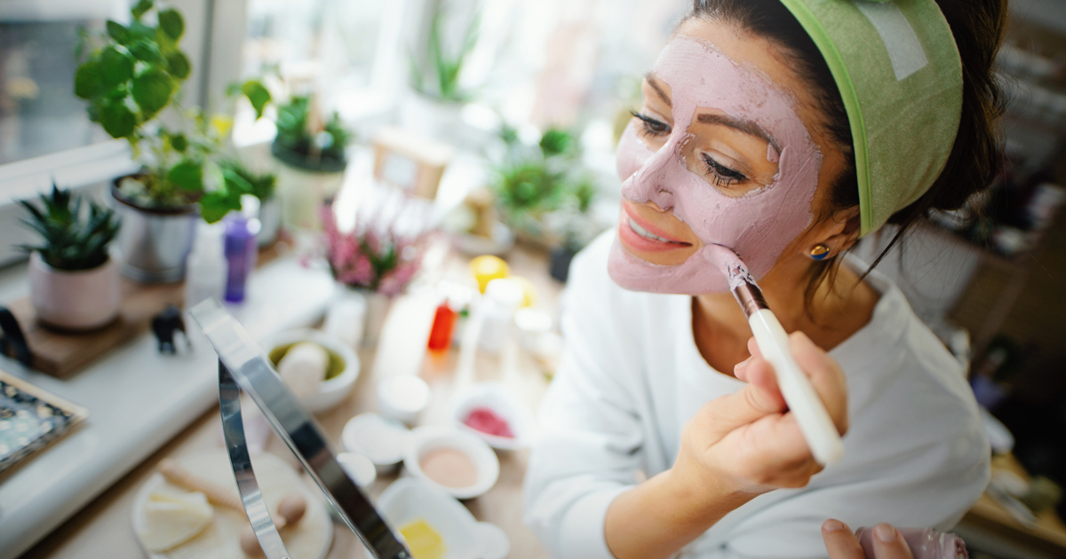 Woman putting on a face mask
