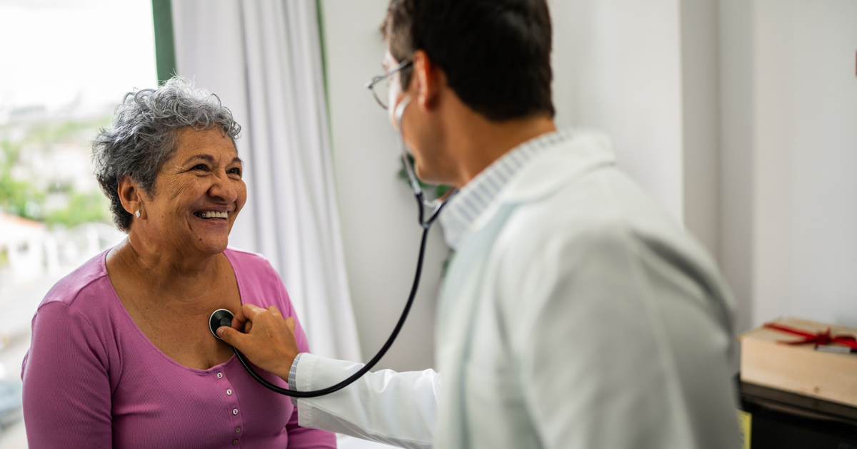 Doctor checking woman's heart