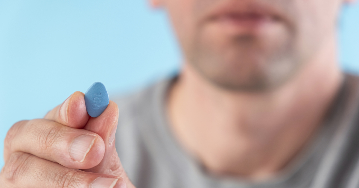 Man holding blue pill