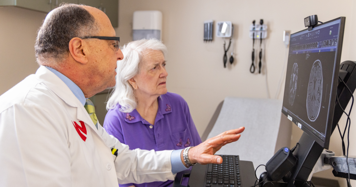 Dr. Fayad looks at brain scans with older female patient