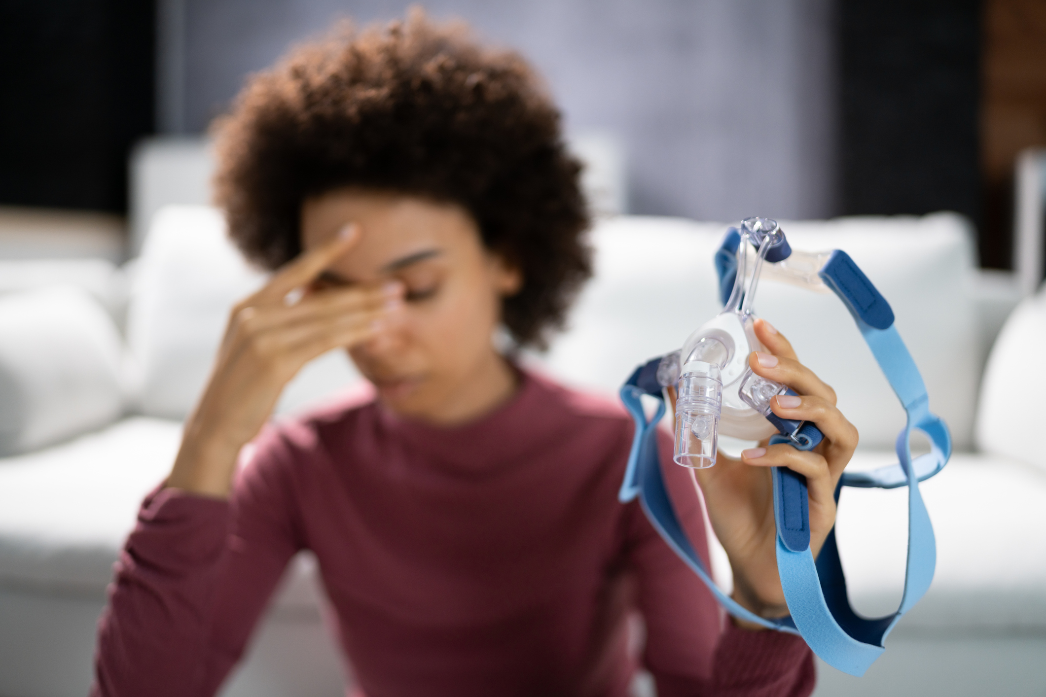 Woman holding CPAP mask