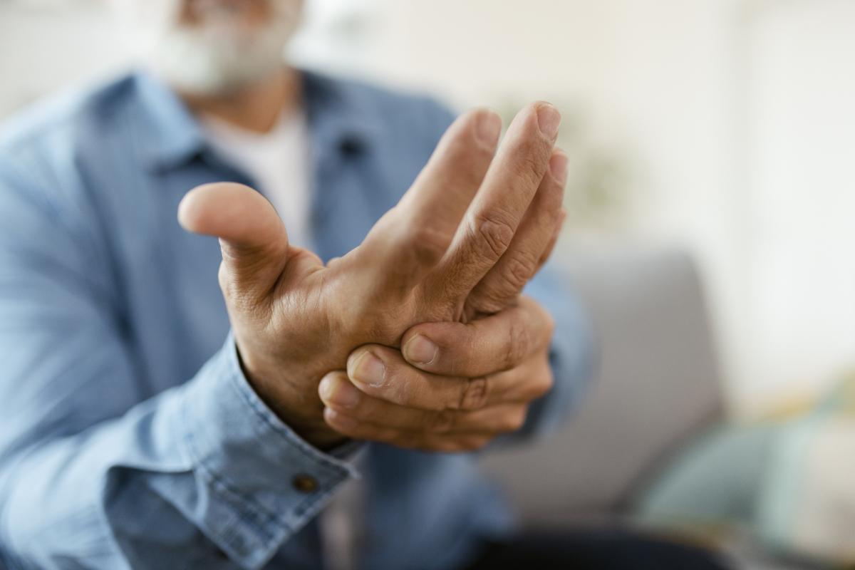 Close up of man holding his hand