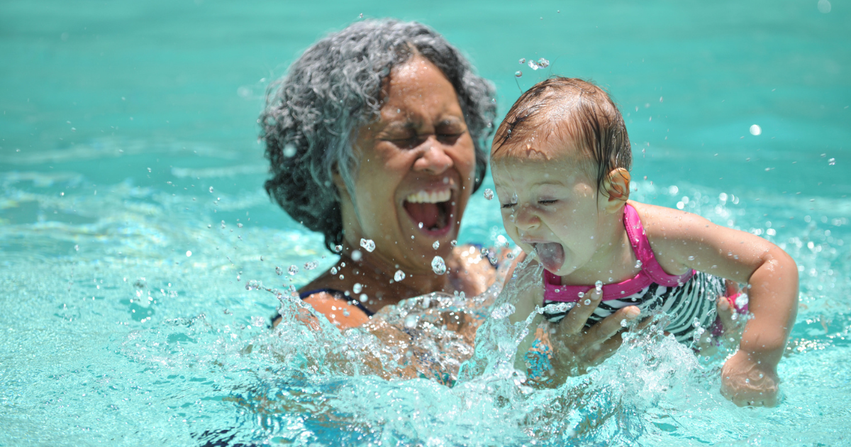 Grandmother and granddaughter swimming