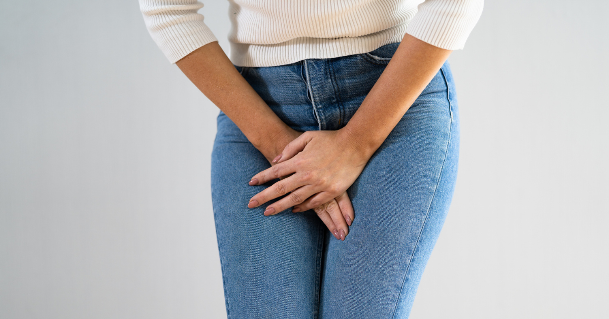Close up of woman holding her groin