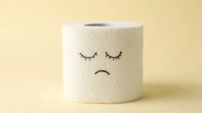 picture of a toilet paper roll with a sad face