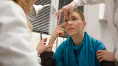 Woman in a doctor's office having her nose evaluated