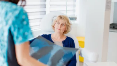 Woman reviewing lung scans with her doctor
