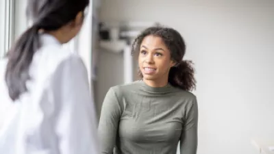 Young woman talking to her doctor