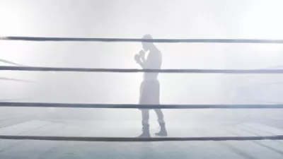 Boxer standing in a foggy boxing ring