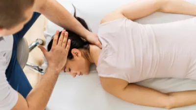 Woman getting adjusted by chiropractor