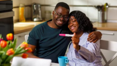 Happy couple looking at a pregnancy test