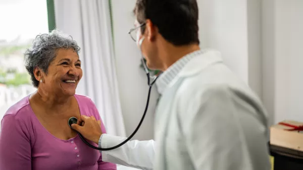 Doctor checking woman's heart