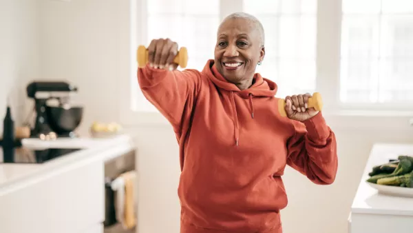 Woman with hand weights in her kitchen