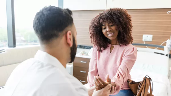 Woman with wrist pain talking to doctor