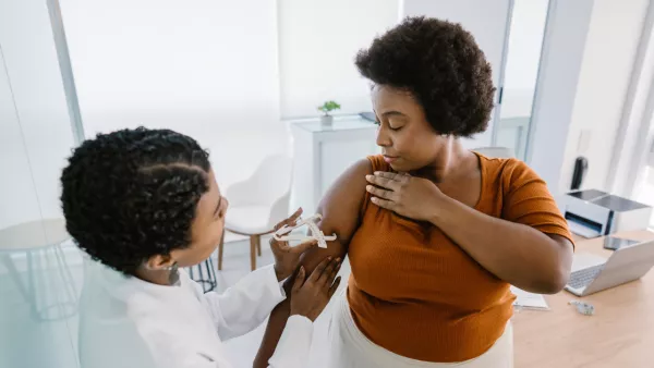 Doctor measuring woman's arm