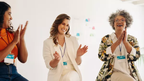 Three women clapping