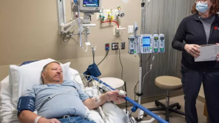 Chad Stevens traveled from his home in eastern Idaho in mid-October for an infusion with a gene therapy for hemophilia B. Here, he is overseen by Sarah Steffes, infusion staff nurse lead.