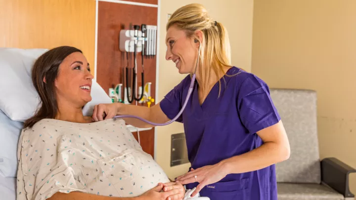 Nurse midwife Alyssa Fischer, APRN-CNM, with a patient.