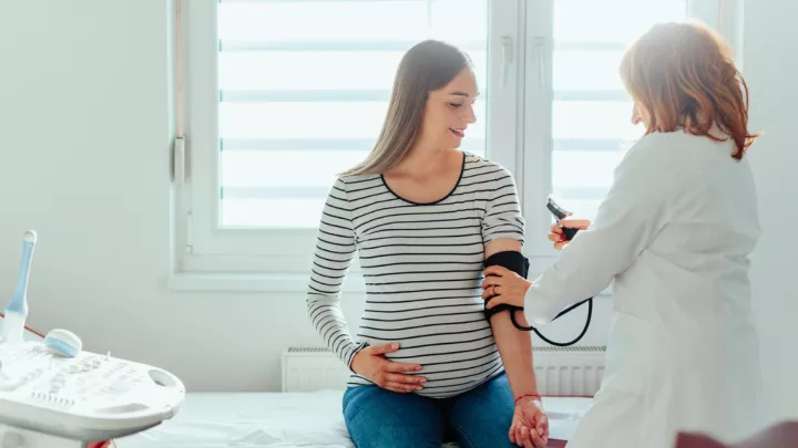 Pregnant woman getting her blood pressure checked