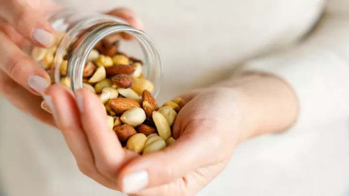 Woman pouring nuts from jar