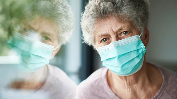 Old woman wearing a mask