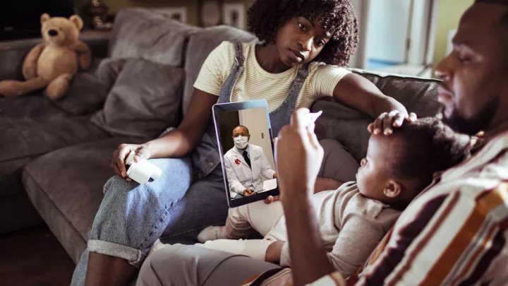 Mother, father, and young son on virtual visit with NM provider