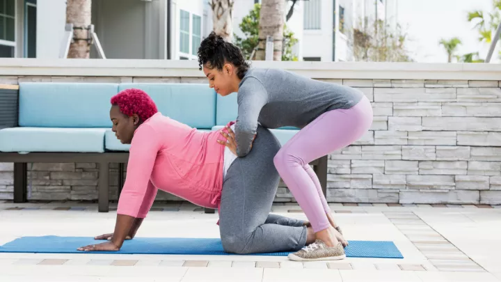 Midwife providing counter pressure to pregnant woman