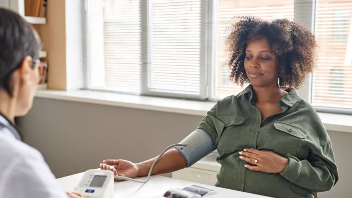 Pregnant woman getting blood pressure checked